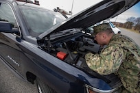 Navy Senior Chief Intelligence Specialist Damon Cable, assigned to the Joint Task Force Civil Support (JTF-CS) security department, performs a weekly maintenance check on one of the command’s deployable vehicles.