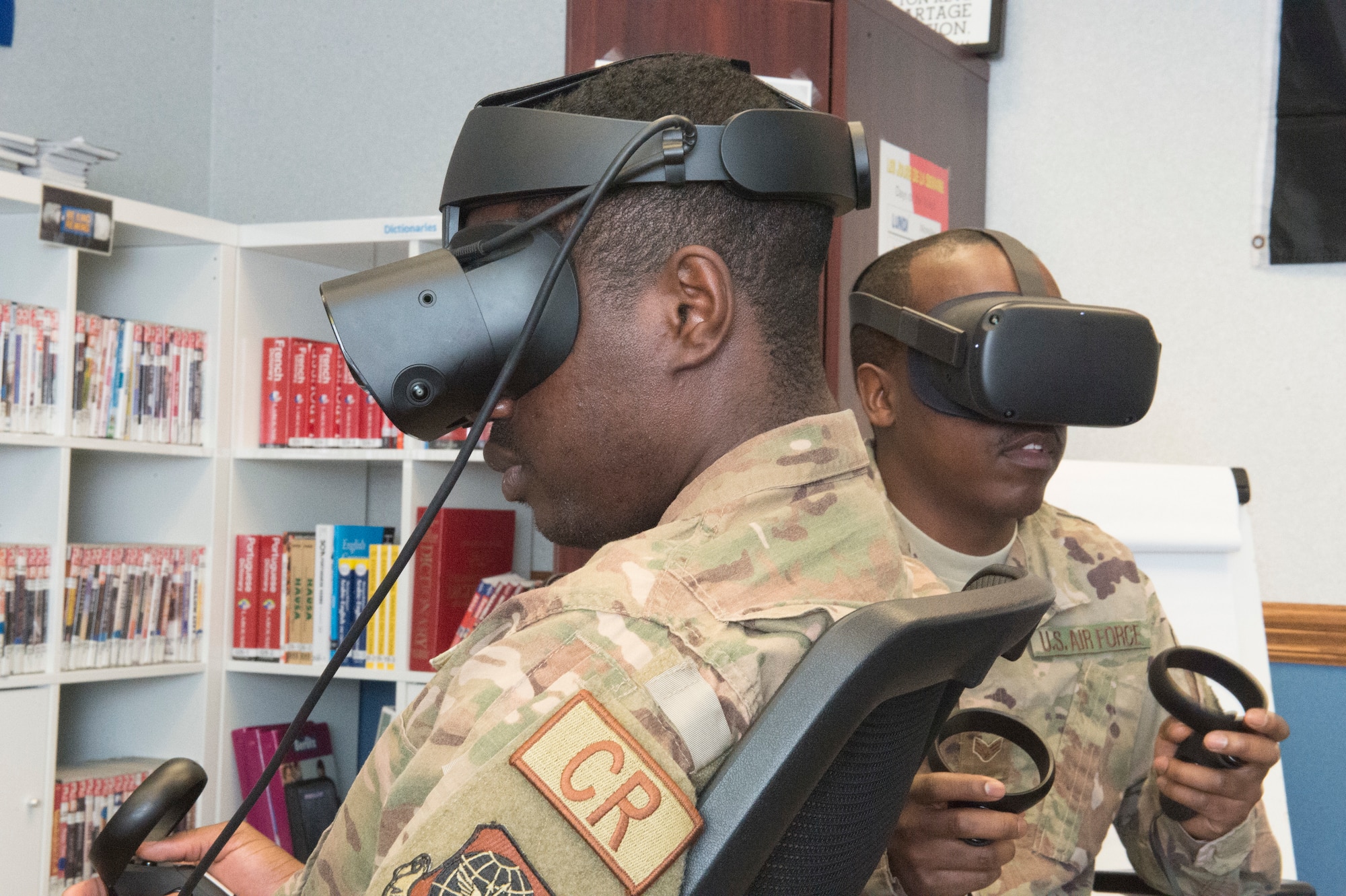 Airman 1st Class Etchy Tambe (left) and Senior Airman Trevaughn Taylor (right), 621st Contingency Response Squadron aerial porter journeymen, test out the French language virtual reality programs at the Language Learning Center at Joint Base McGuire-Dix-Lakehurst, New Jersey, Mar. 3, 2019. The LLC was created to help Airmen from the 818th Mobility Support Advisory Squadron maintain French language proficiency for their frequent trips to Africa in support of developing air mobility capabilities. (U.S. Air Force photo by Staff Sgt. Sarah Brice)
