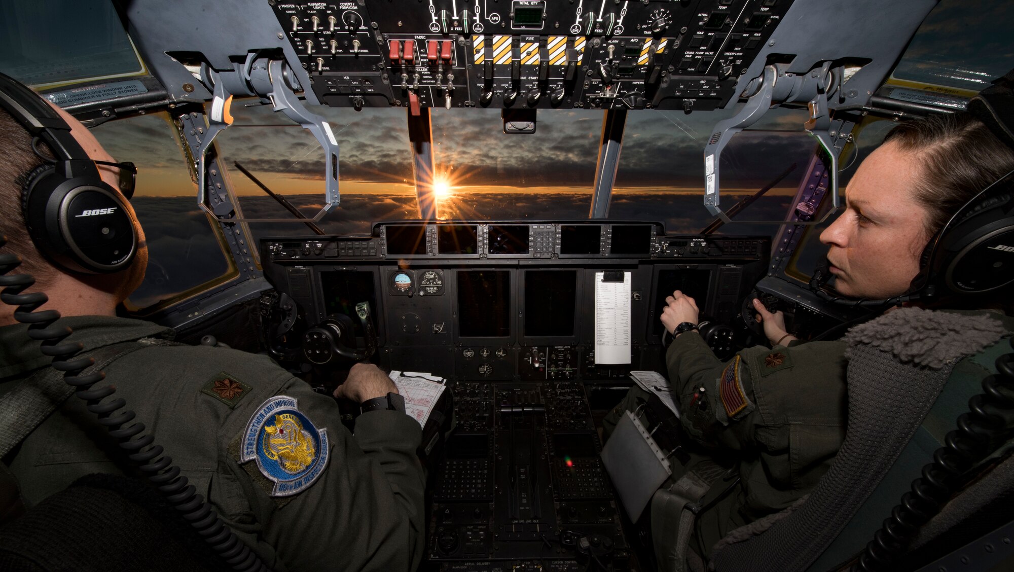 U.S. Air Force Maj. Mary Baldwin and Maj. Benn Slikker, 37th Airlift Squadron C-130J Super Hercules aircraft pilots, fly a C-130J over Germany.