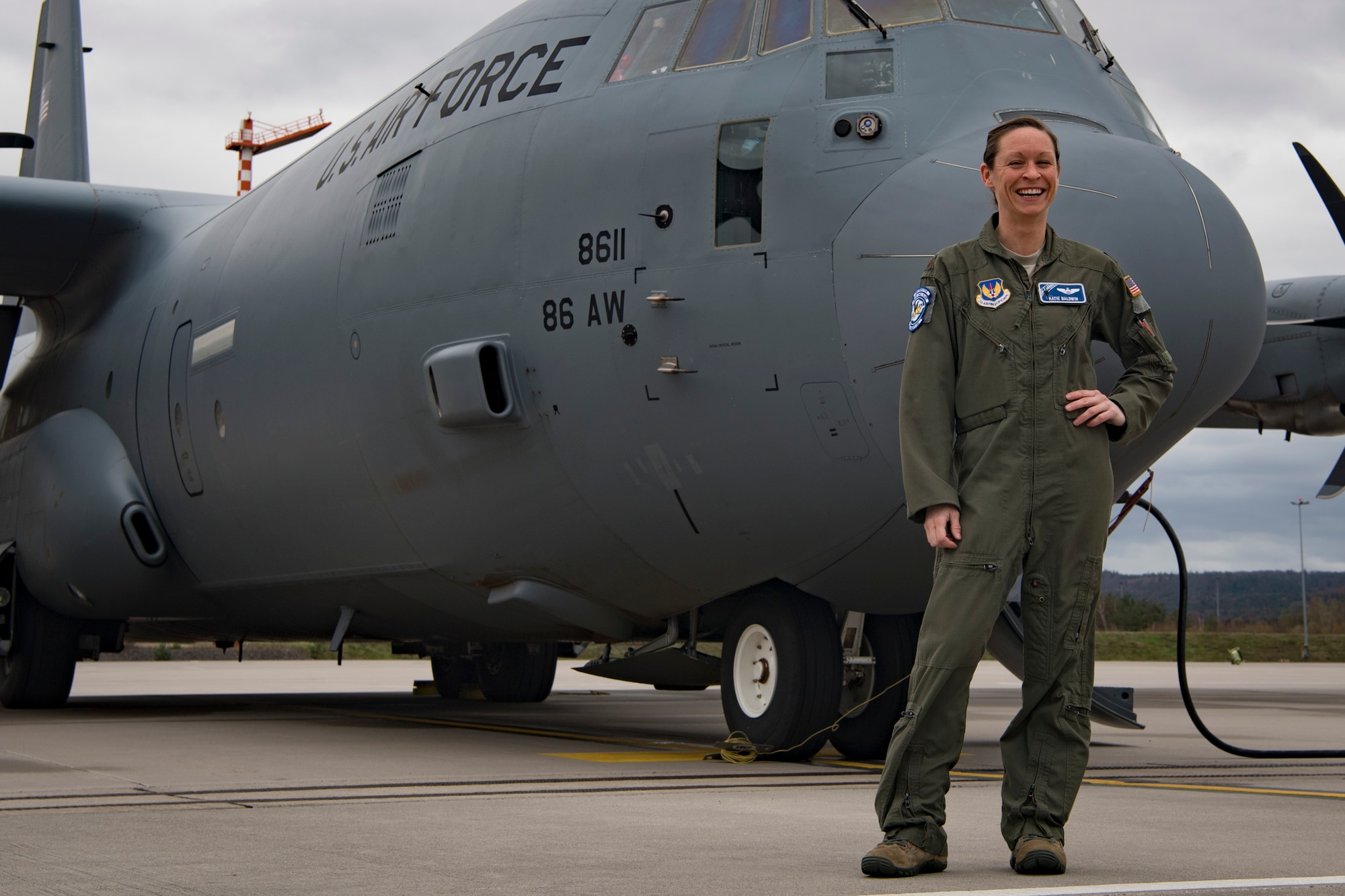 U.S. Air Force Maj. Mary Baldwin, 37th Airlift Squadron C-130J Super Hercules aircraft pilot, stands in front of a C-130J.