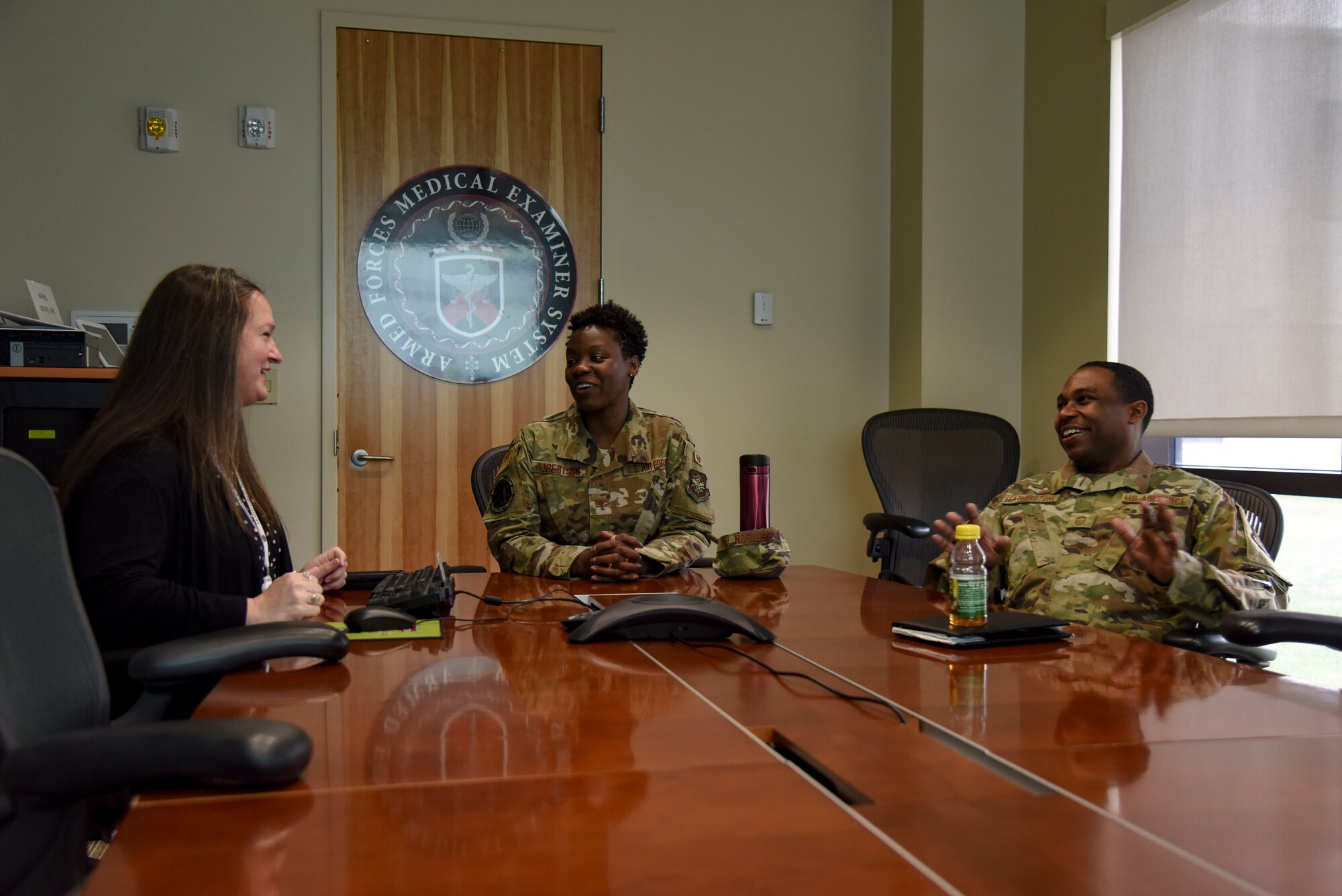 Col. Angenene Robertson, Air Mobility Command manpower, director of personnel and services, and Chief Master Sgt. Gregory Featherstone, Air Mobility Command chief enlisted manager of readiness and integration, and services functional manager, speaks with Jennifer Vallee, Armed Forces Medical Examiner System chief of public and congressional affairs, during an AFMES tour March 10, 2020, at Dover Air Force Base, Delaware. Robertson and Featherstone visited the base for an immersion, where they learned in-depth details about many organizational missions and day-to-day operations including the Air Force Mortuary Affairs Operations and AFMES (U.S. Air Force photo by Senior Airman Eric M. Fisher)