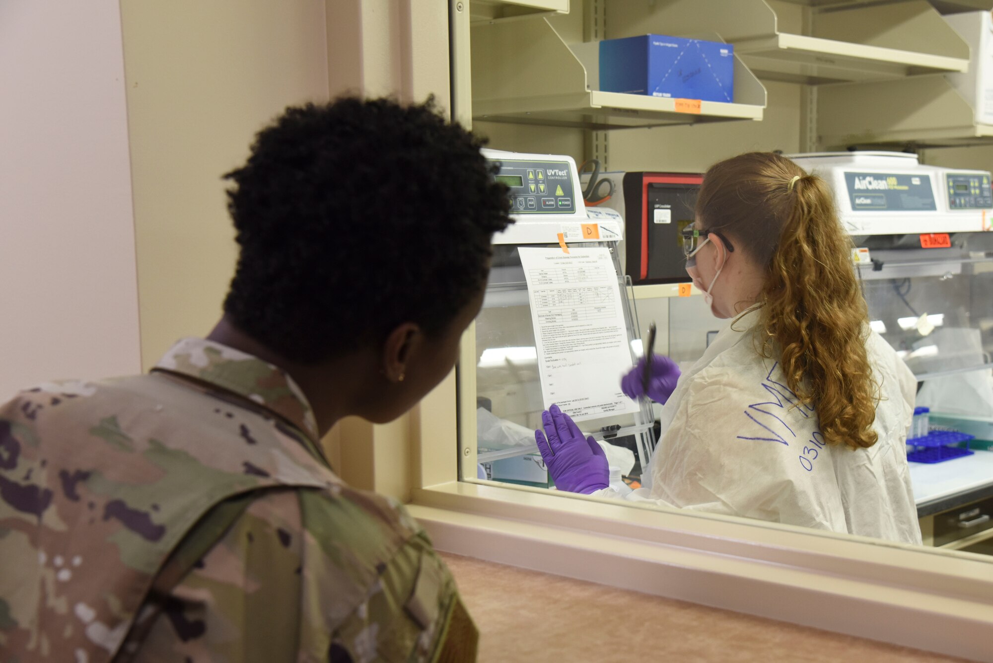 Col. Angenene Robertson, Air Mobility Command director of manpower, personnel and services, watches as DNA tests are conducted on osseous material from a potential MIA service member during a tour of the Armed Forces Medical Examiner System March 10, 2020, at Dover Air Force Base, Delaware. AFMES is responsible for testing hundreds of DNA samples each year to help identify remains. (U.S. Air Force photo by Senior Airman Eric M. Fisher)