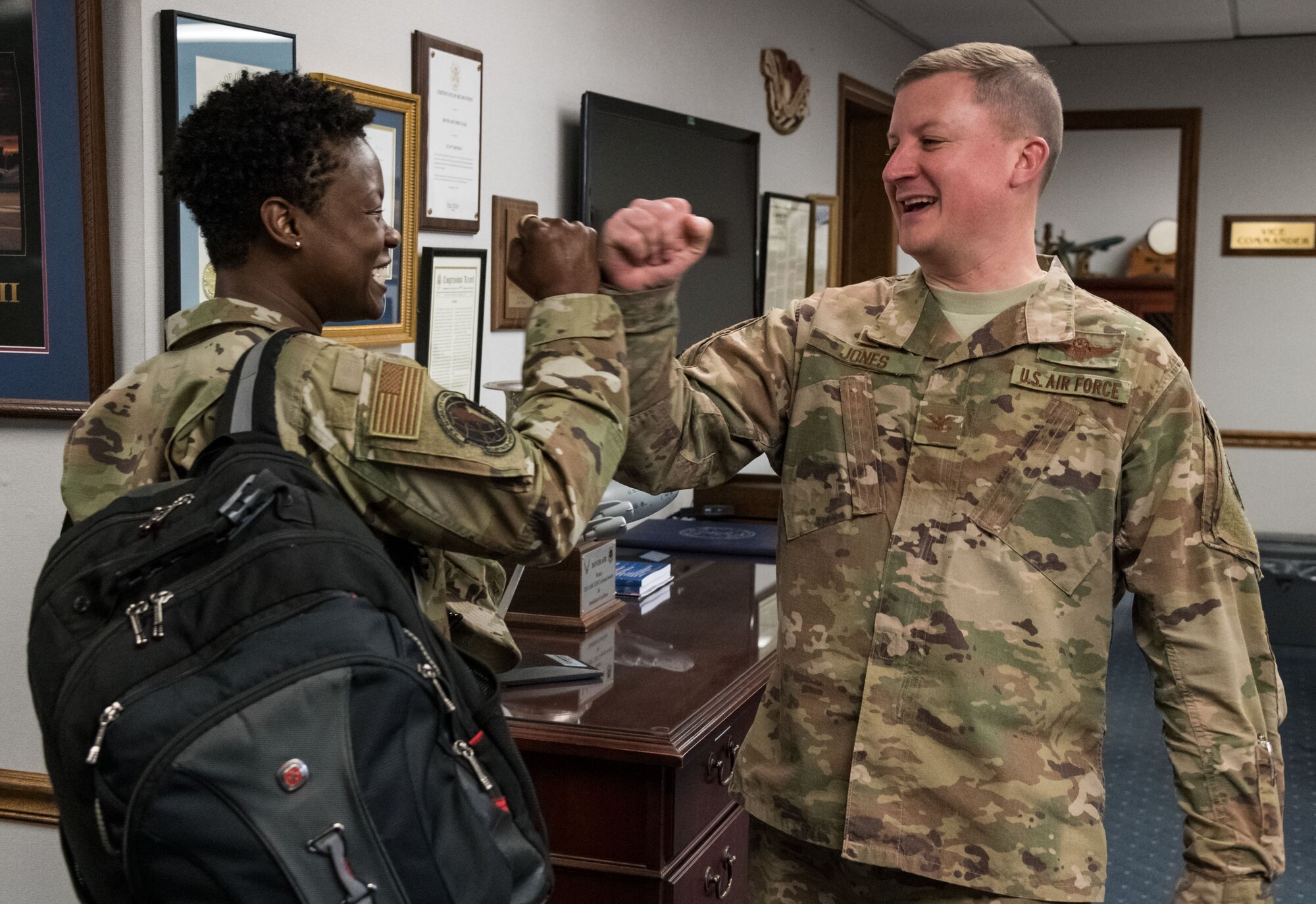 Col. Matthew Jones, 436th Airlift Wing commander, greets Col. Angenene Robertson, Air Mobility Command director of manpower, personnel and services, with a fist bump March 11, 2020, on Dover Air Force Base, Delaware. Robertson visited the base for an immersion, where she learned in-depth details about many organizational missions and day-to-day operations. (U.S. Air Force photo by Roland Balik)
