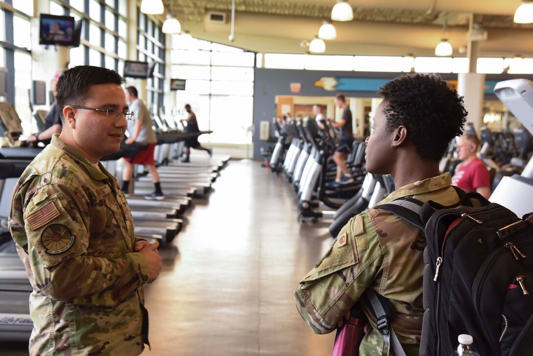 Col. Angenene Robertson, Air Mobility Command director of manpower, personnel and services, speaks with Tech. Sgt. Oscar Vazquez, 436th Force Support Squadron noncommissioned officer in charge of the fitness center, during a tour March 12, 2020, at Dover Air Force Base, Delaware. Robertson visited the base for a Dover AFB force support immersion where she learned in-depth details about each organization’s mission and day-to-day operations. (U.S. Air Force photo by Senior Airman Eric M. Fisher)