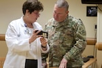 Denise Reynolds, left, the chief nursing officer at Memorial Hospital West, discusses tactics for the coronavirus drive-through testing facility with Maj. Mark Sullivan, with the Florida National Guard’s medical detachment, March 16, 2020. The Florida National Guard is mobilizing up to 500 Citizen-Soldiers and Airmen in support of the Florida Department of Health's response in Broward County.