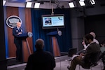 Navy Adm. Charles A. Richard, commander of U.S. Strategic Command, briefs reporters at the Pentagon via telephone from Offutt Air Force Base, Neb., about Stratcom's response to COVID-19, March 17, 2020. The admiral is pictured on the monitor.