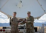 Lt. Col William Sanders, left, 4th Space Control Squadron commander, receives the Counter Communications System Block 10.2 from Lt. Col. Stephen Brogan, right, combat systems branch materiel leader at the Space and Missile Systems Center at Los Angeles Air Force Base, Calif., March 12 on Peterson Air Force Base, Colo. Once handed over, the B10.2 became the first offensive weapon system assigned to the United States Space Force.