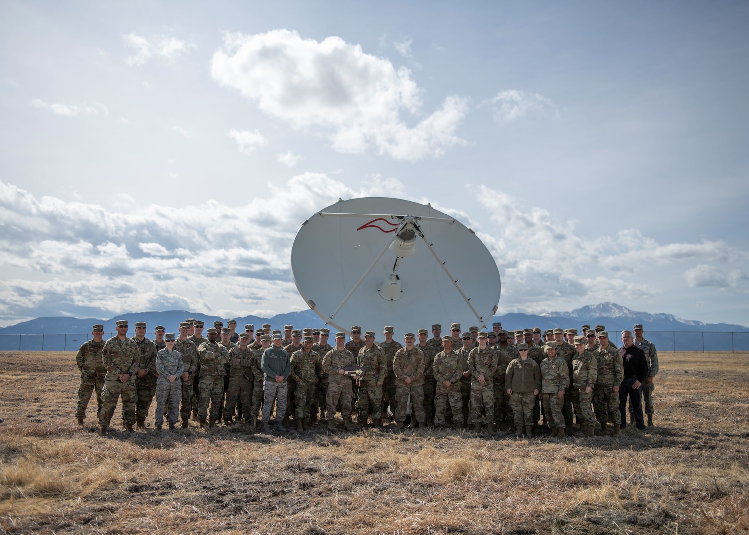 Airmen from the 4th Space Control Squadron take a picture in front of the Counter Communications System Block 10.2 on March 12, 2020, on Peterson Air Force Base, Colo. The 4th SPCS received the B10.2 from the Space and Missile Systems Center on Los Angeles Air Force Base, Calif., making it the first offensive weapon system assigned to the United States Space Force.