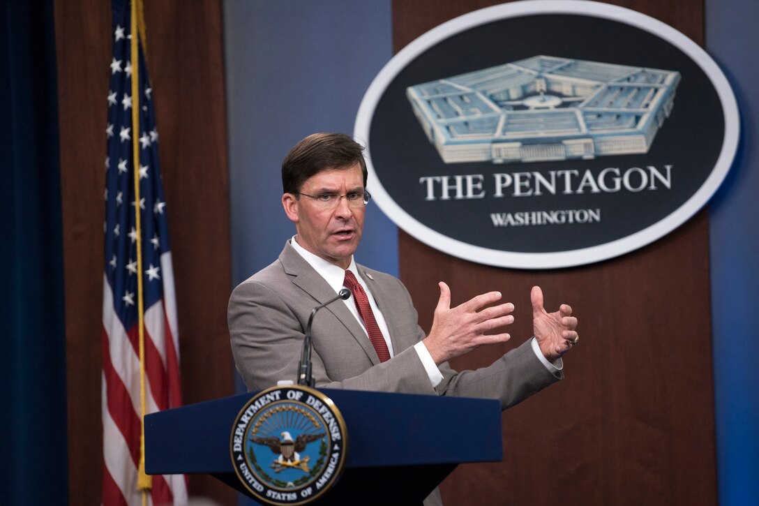 Defense Secretary Dr. Mark T. Esper speaks at a lectern.