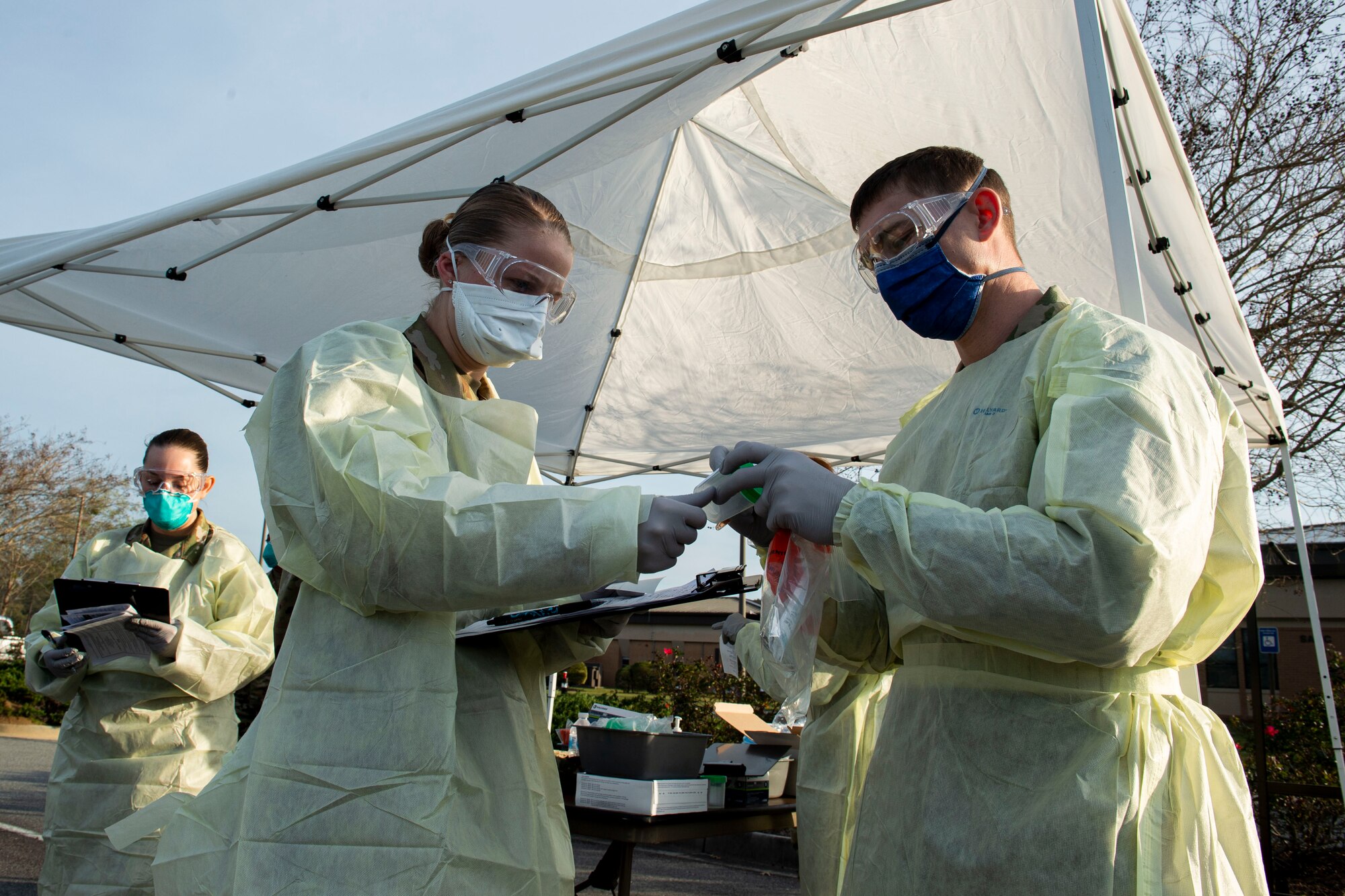Photo of Airmen preparing for a drive-through health screening.