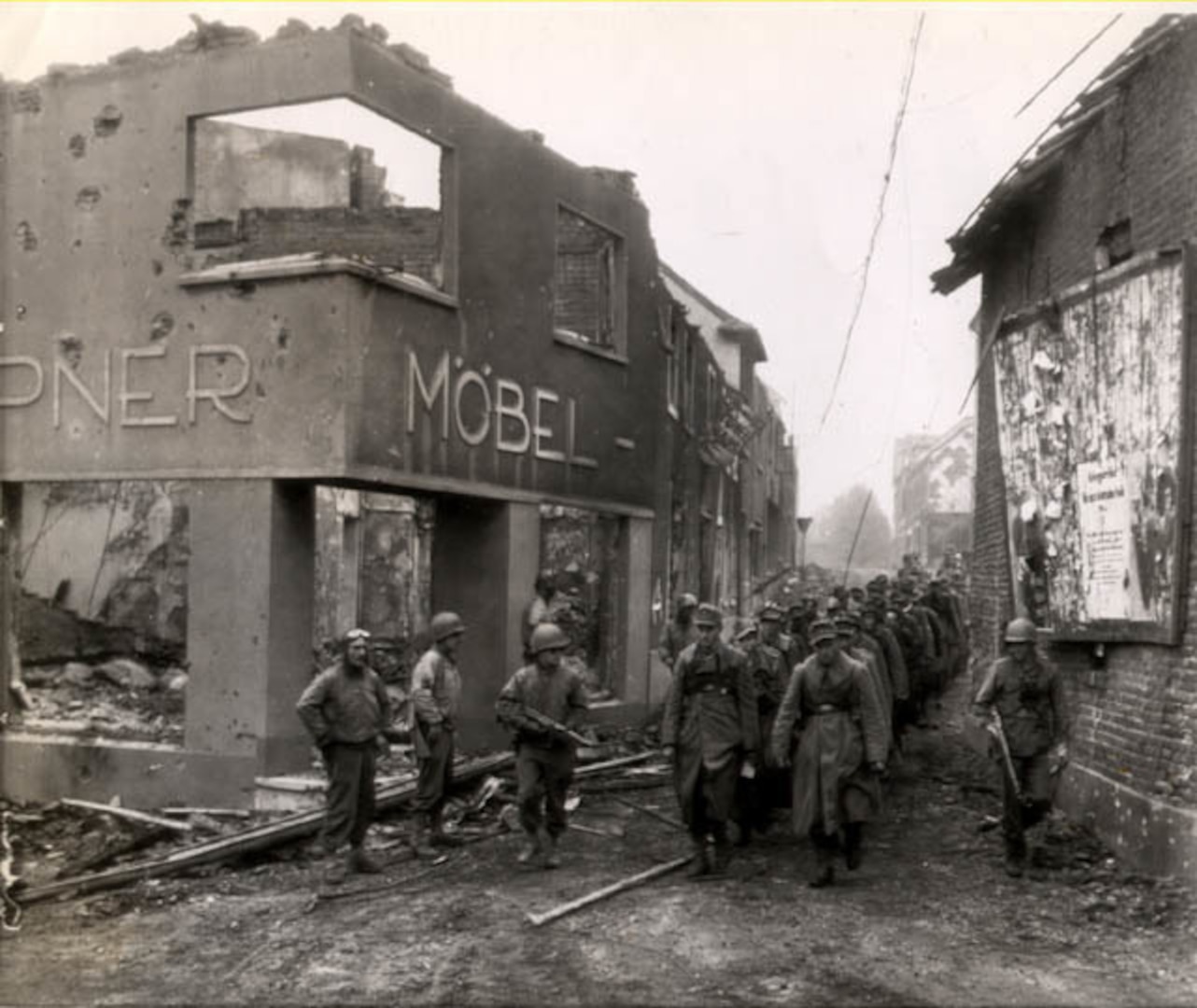 Some 117th Infantry Regiment, 30th Infantry Division and 2nd Armored Division Soldiers with captured German troops near the Siegfried Line - Palenburg, Germany, October 1944.