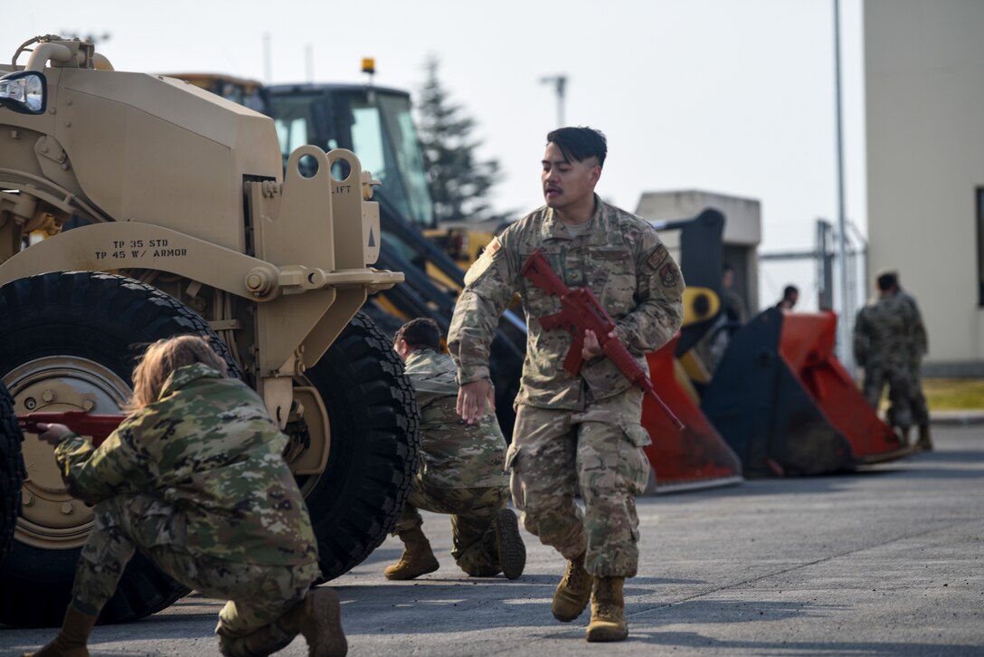 U.S. Air Force Senior Airman John Kuthmann, a patrolman with the 35th Security Forces Squadron, performs a status check with other Airmen after a simulated attack during an Agile Combat Employment practice capstone event at Misawa Air Base, Japan, March 13, 2020. During the event, Airmen switched out from assisting with other tasks to learn how to perform security patrols and defend their position. (U.S. Air Force photo by Tech. Sgt. Timothy Moore)