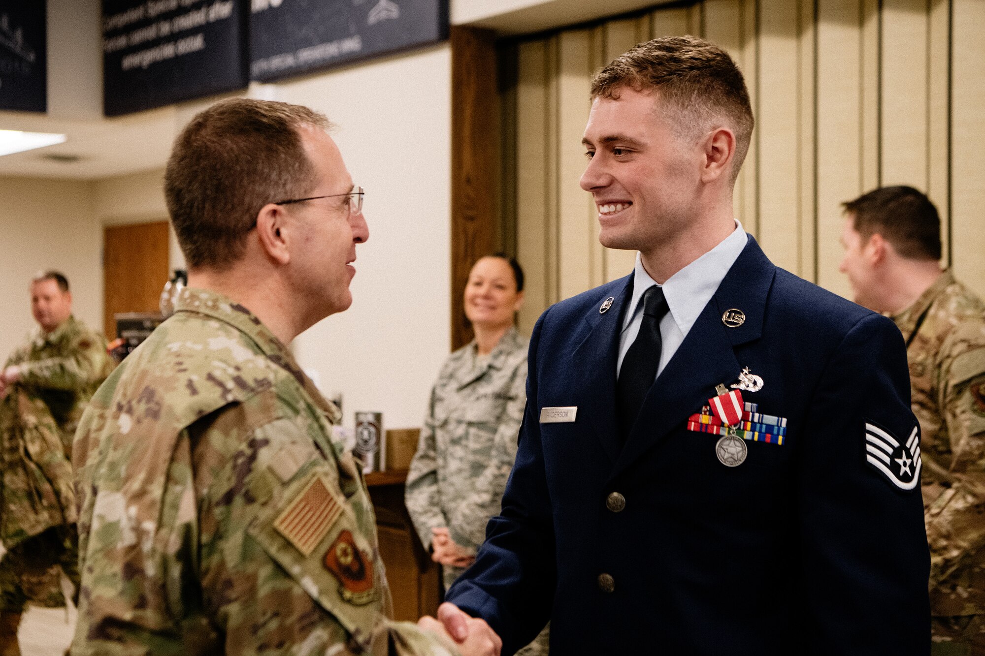 Staff Sgt. Benjamin Anderson, an air freight journeyman assigned to the 137th Special Operations Logistics Readiness Squadron, shakes hands with distinguished guest U.S. Air Force Lt. Gen. Jim Slife, commander of Air Force Special Operations Command, after an Oklahoma Star of Valor ceremony March 7, 2020, at Will Rogers Air National Guard Base, Oklahoma City. Slife was among many distinguished guests and attendees present at the ceremony honoring the heroic actions of Anderson.