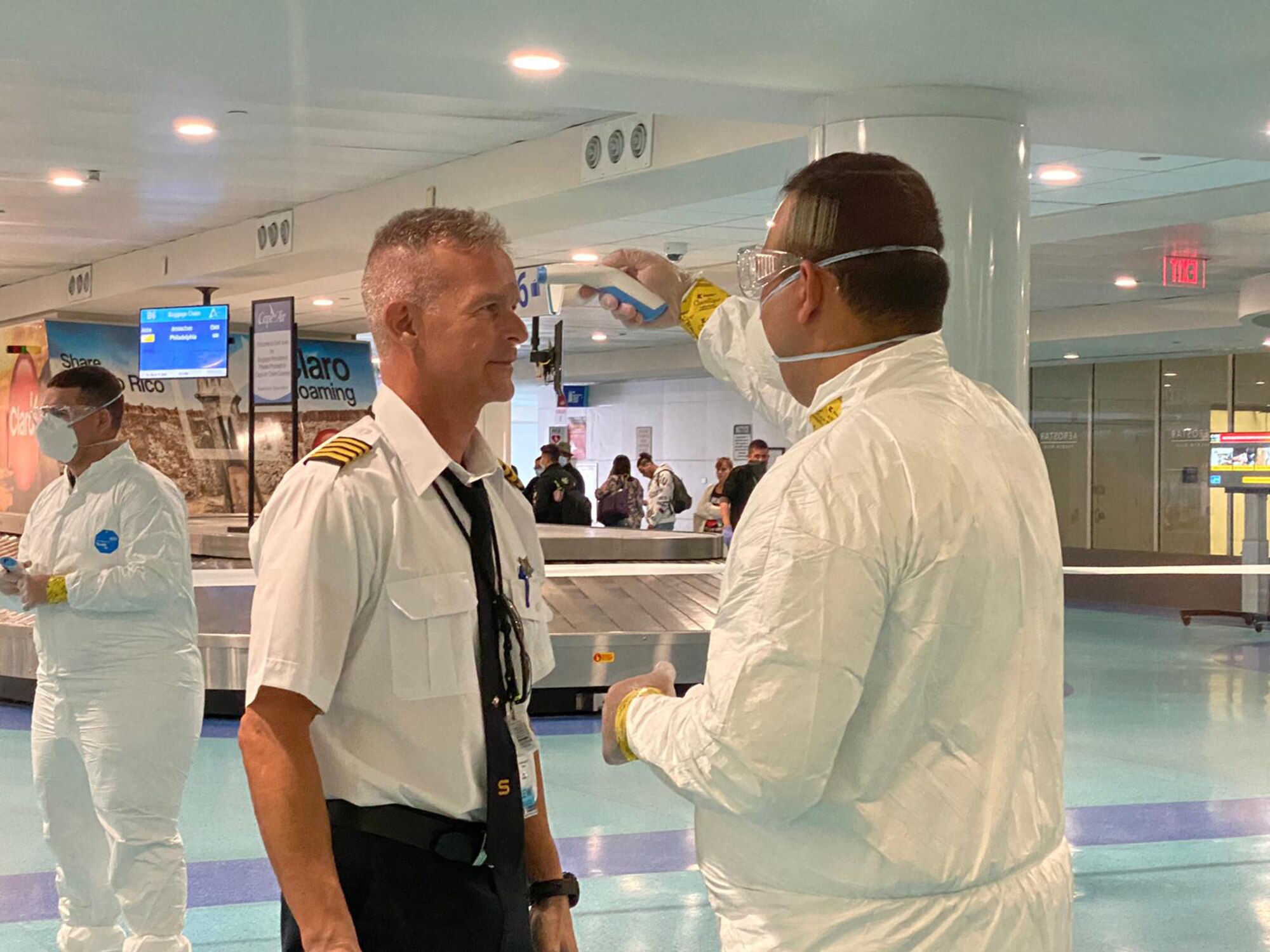 More than 280 Airmen and Soldiers, assigned to the Puerto Rico National Guard are working alongside the Department of Health and other state and federal agencies to screen passengers arriving at Luis Muñoz Marín International Airport in Carolina, Puerto Rico, to detect any suspected case of COVID-19 and avoid more infections, March 17, 2020. (Photo by Puerto Rico National Guard)