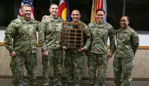 Maj. Timothy Biart, Capt. Skye Robinson, Sgt. 1st Class Sean Clark, 1st Lt. Christopher Giron and Sgt. Nadia Carter of Delta Crew, show off the 100th Missile Defense Brigade (Ground-based Midcourse Defense) Top Crew award at the brigade's headquarters in Colorado Springs, Colorado,  March 5, 2020. The Soldiers were also awarded the Army Commendation Medal for their respective contributions to Delta Crew in 2019. (Photo by U.S. Army National Guard Staff Sgt. Zach Sheely)