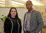 Gabriela Moraga, a Medical tailored vendor logistics specialist, left, and Peter Skillings, Medical’s Collective and Foreign Military Sales branch chief, right, pose for a photo at DLA Troop Support March 13, 2020 in Philadelphia.