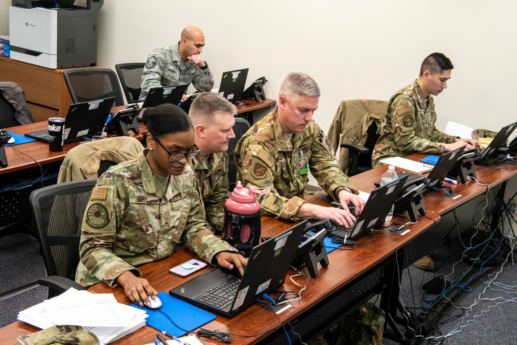 Members of the 436th Airlift Wing Crisis Battle Staff work on Dover Air Force Base’s response to COVID-19 March 16, 2020, at Dover AFB, Delaware. The team is committed to protecting the health of our communities and will continue to monitor and assess the situation. (U.S. Air Force photo by Senior Airman Christopher Quail) (This photo has been altered for security purposes by blurring out identification badges)