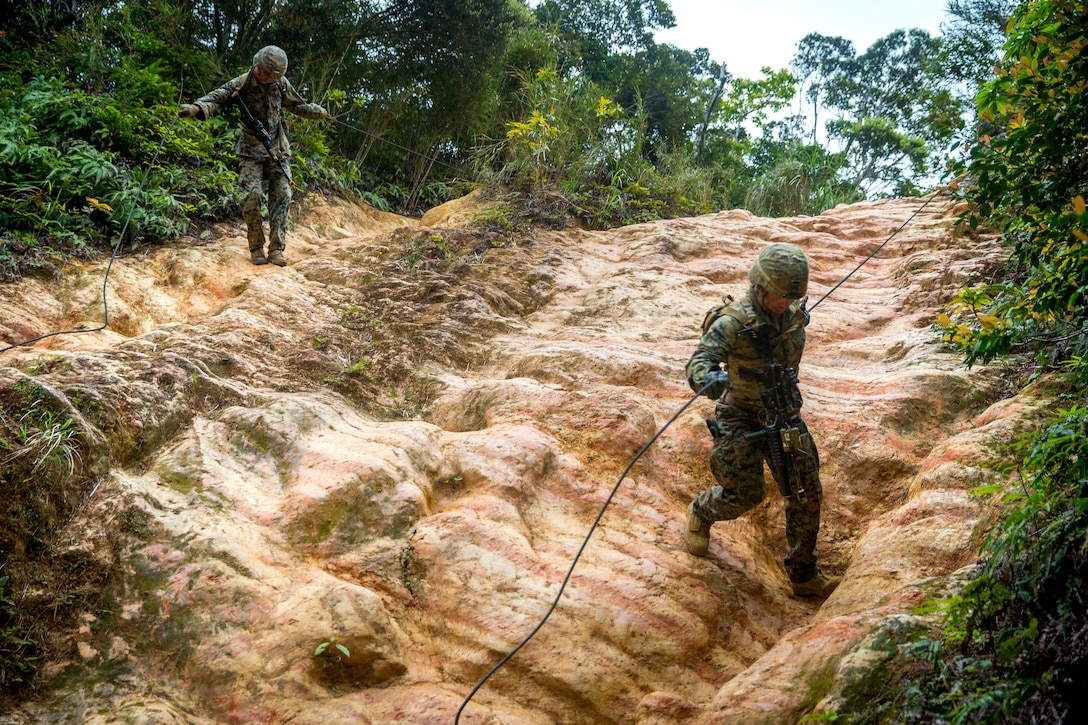 U.S. Marines assigned to 3rd Marine Division perform a hasty rappel during a squad competition at the Jungle Warfare Training Center in Okinawa, Japan, March 18. The competition was held to evaluate standards-based infantry training.