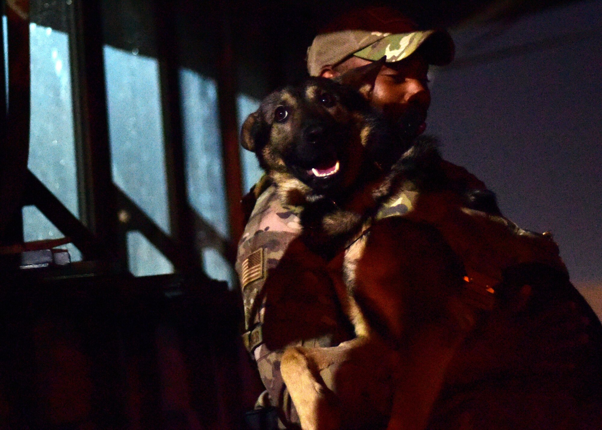 Dog handler embraces his canine