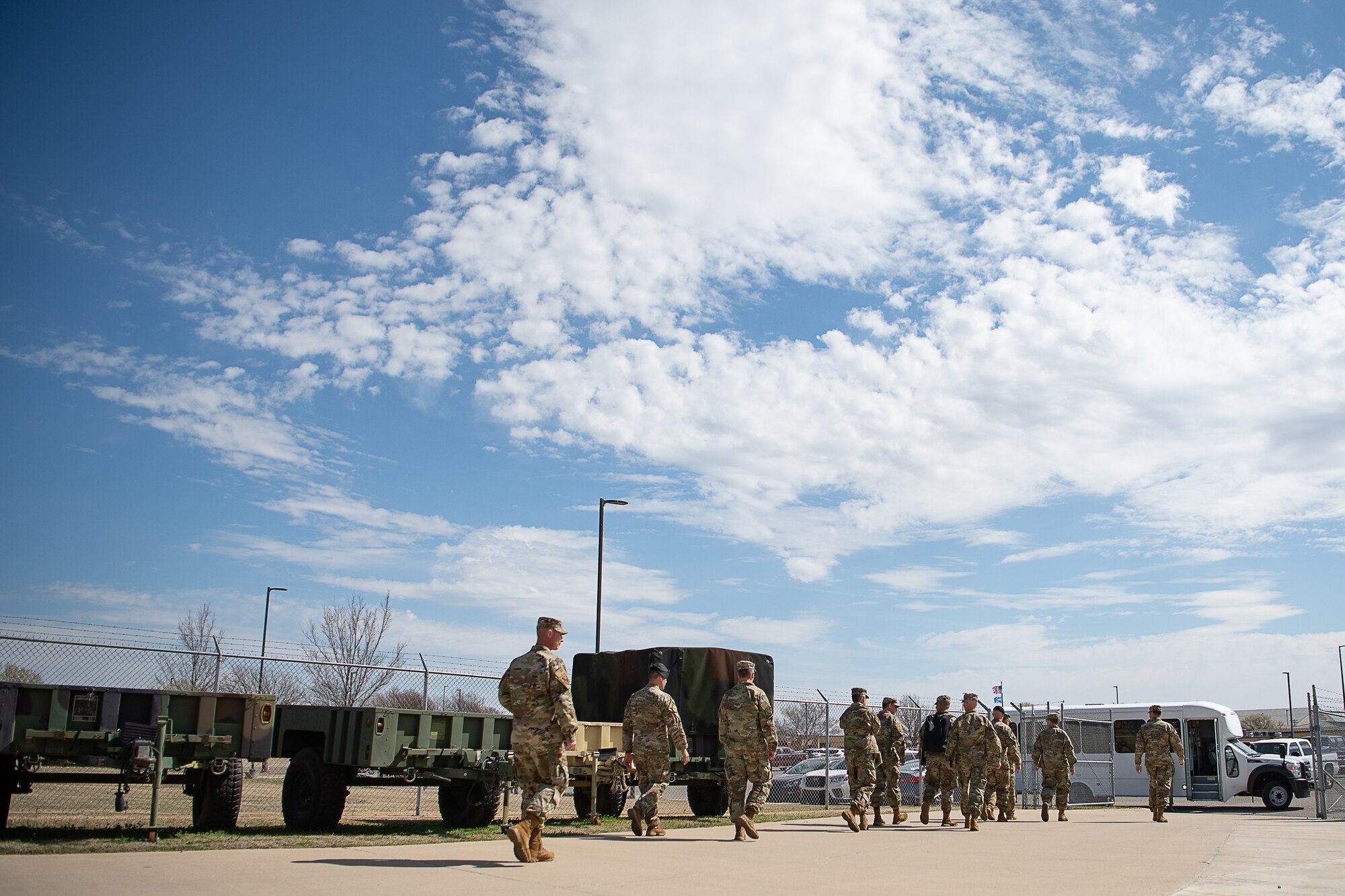Military officials from U.S. Air Force Special Operations Command walk through the 146th Air Support Operations Squadron motor pool while taking part in an immersion tour of the 137th Special Operations Wing (137th SOW) at Will Rogers Air National Guard Base in Oklahoma City, March 7, 2020. The two-day immersion not only included a tour of base and face-to-face meetings with commanders and Airmen, but also a survey of available land and acreage. (U.S. Air National Guard photo by Tech. Sgt. Kasey M. Phipps)