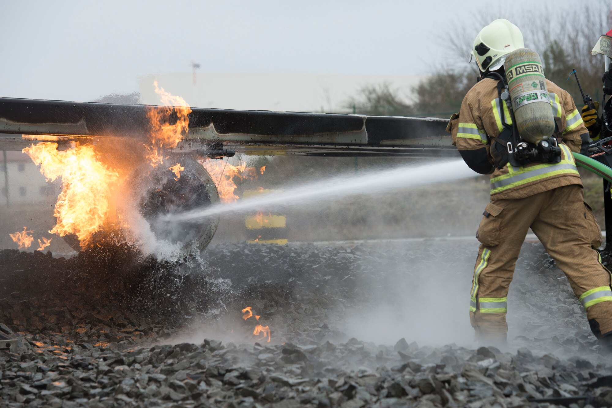 Photo of firefighter extinguishing flames.