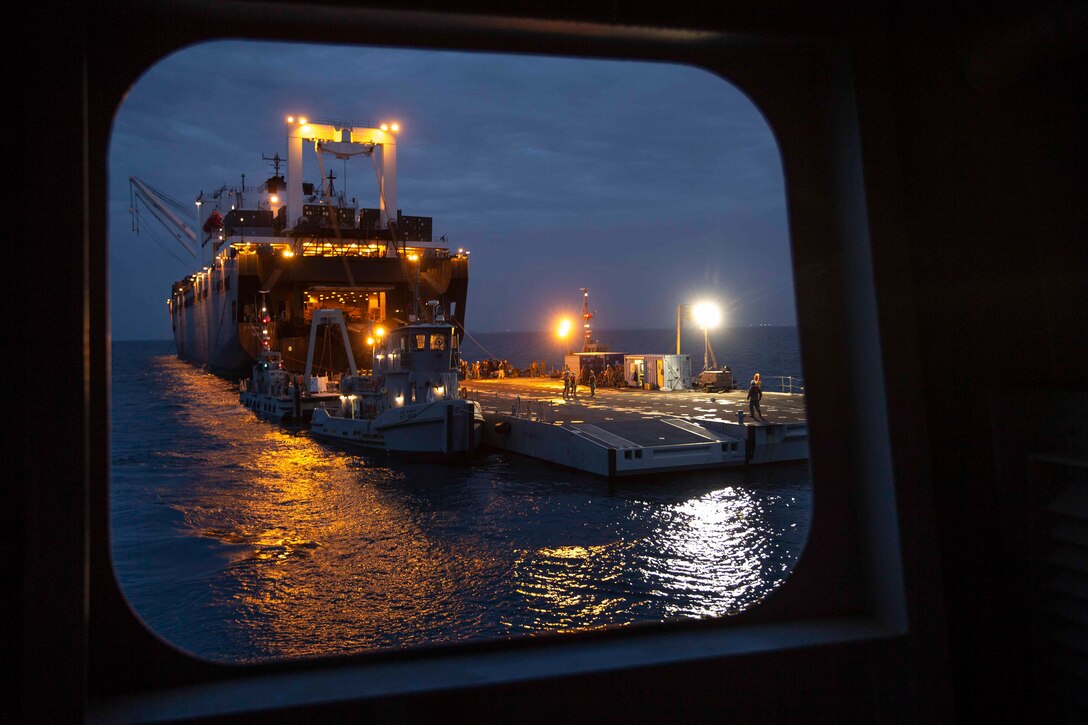 A ship seen through a window at night.