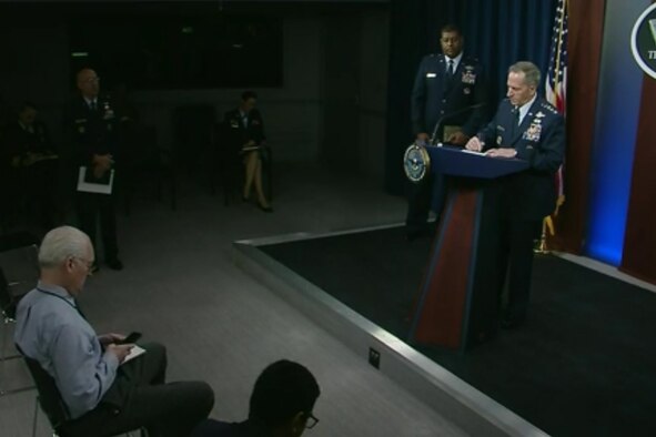 An Air Force general stands in uniform behind a podium.