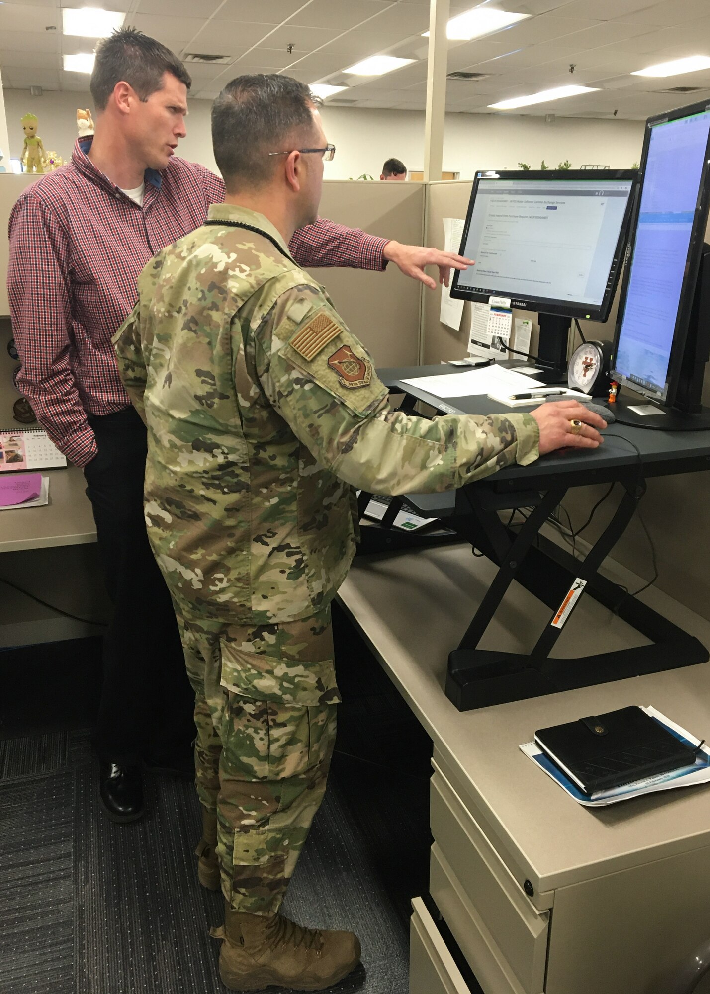 Photo of two men working at a computer
