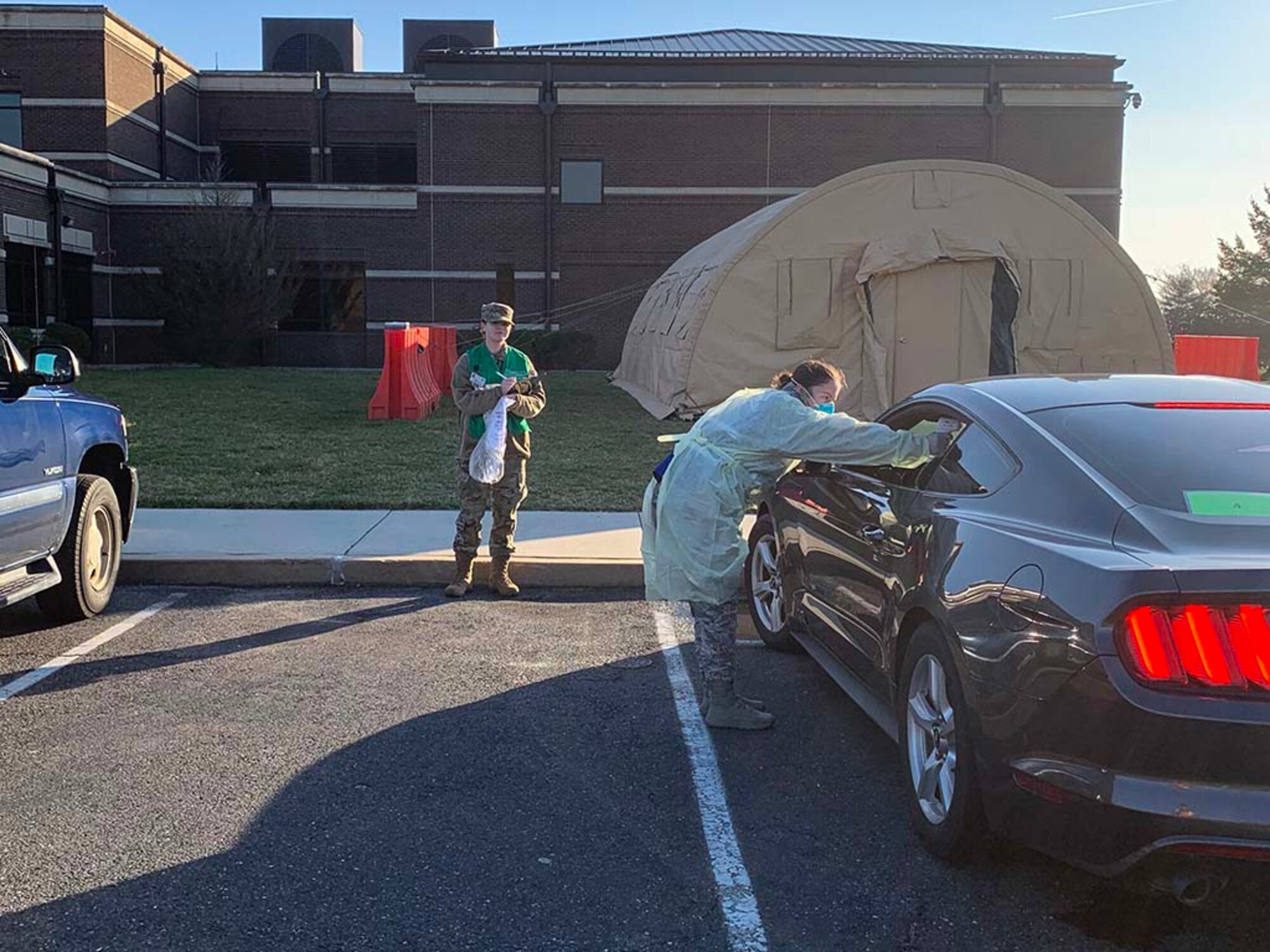 Photo of member administering a COVID-19 test to an individual in their vehicle.
