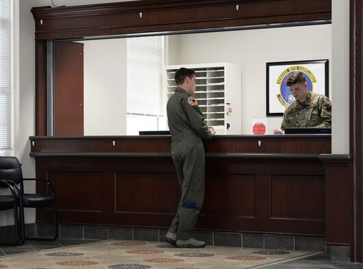 Airman 1st Class Cooper Crum, 14th Comptroller Squadron Financial Services Flight technician, assists a customer with financial information March 18, 2020, on Columbus Air Force Base, Miss. The financial services flight is all about supporting the customer and is essential to ensuring members of the 14th Flying Training Wing are taken care of financially so they can focus on getting the mission done. (U.S. Air Force photo by Airman 1st Class Hannah Bean)