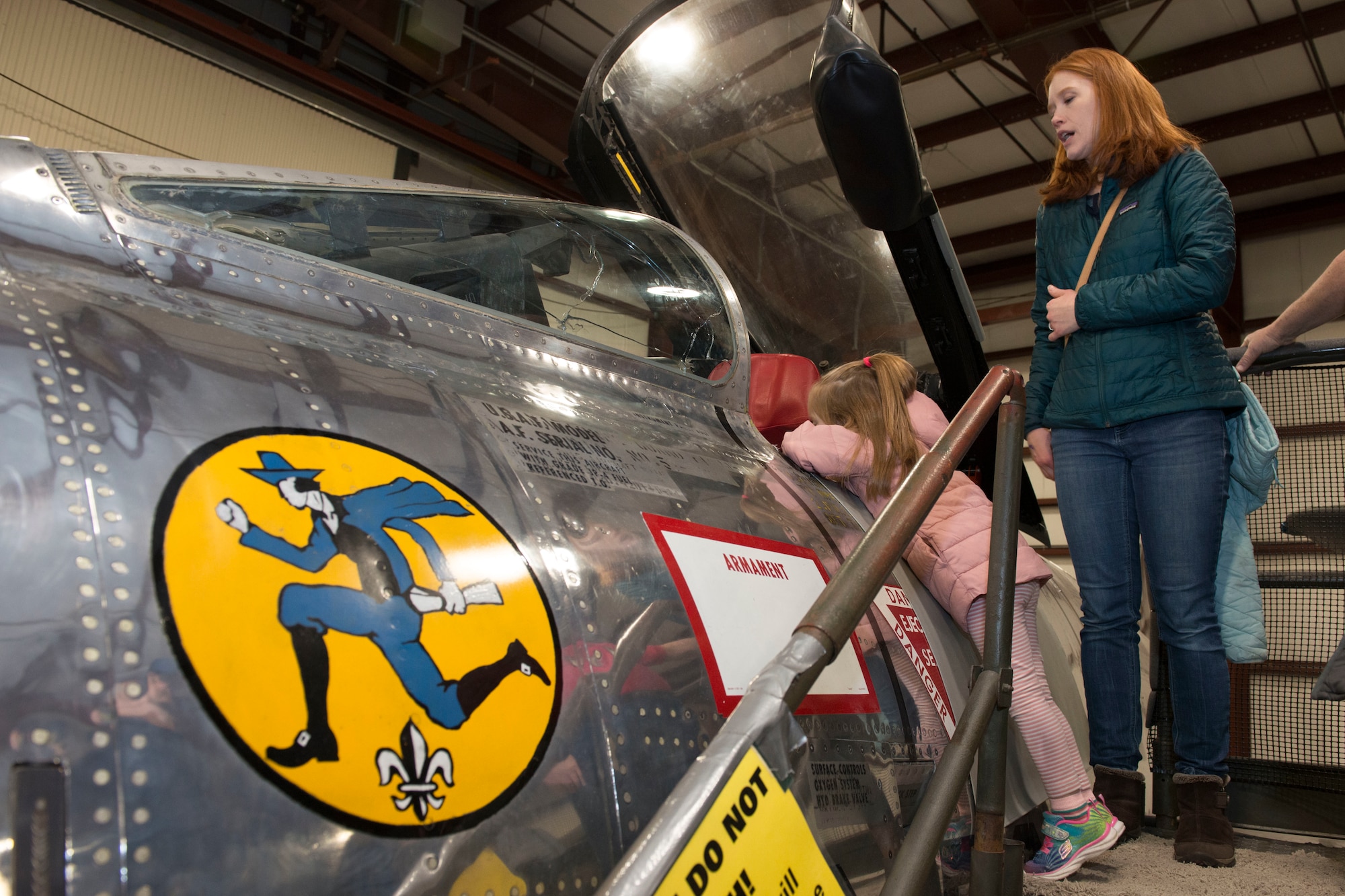 A woman and child view an F-84  Thunderjet static display at the annual "Women Take Flight" event held at the New England Air Museum , Windsor Locks, Connecticut, March 7, 2020. The aircraft was assigned to the 103rd Fighter Group during the Cold War. (U.S. Air National Guard photo by Tech. Sgt. Tamara R. Dabney)