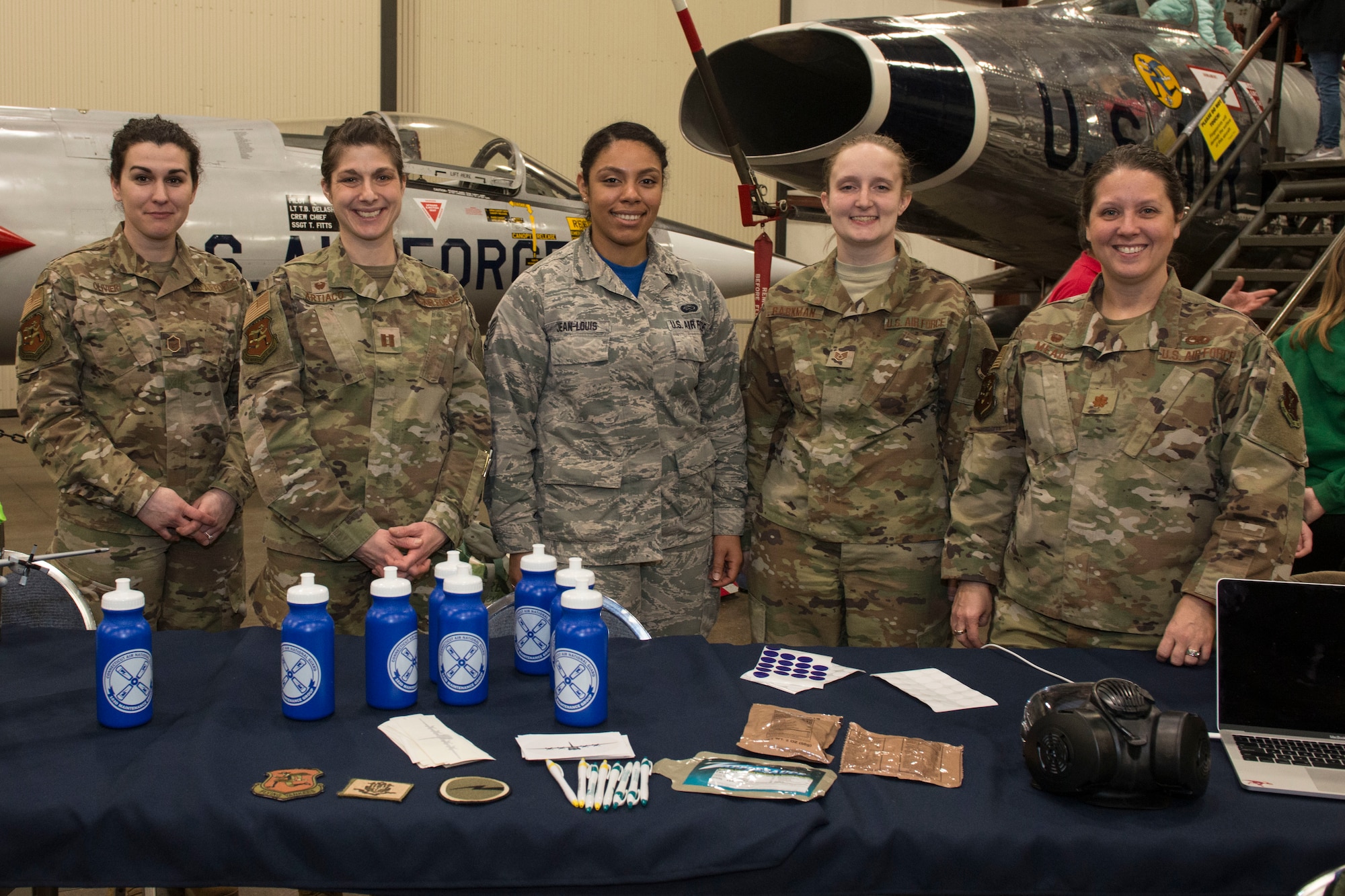 Female airmen assigned to the 103rd Airlift Wing operate a display booth at the annual "Women Take Flight" event held at the New England Air Museum , Windsor Locks, Connecticut, March 7, 2020.  "Women Take Flight" is targeted toward girls who are interested in avionics and other STEM related fields.(U.S. Air National Guard photo by Tech. Sgt. Tamara R. Dabney)