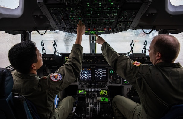 U.S. Air Force Maj. Tien Phung (left) and Maj. Stan Schmotzer (right), 701st Airlift Squadron C-17A Globemaster III pilots, perform pre-flight checks on the aircraft before conducting a local training sortie at Joint Base Charleston, S.C. March 5, 2020.