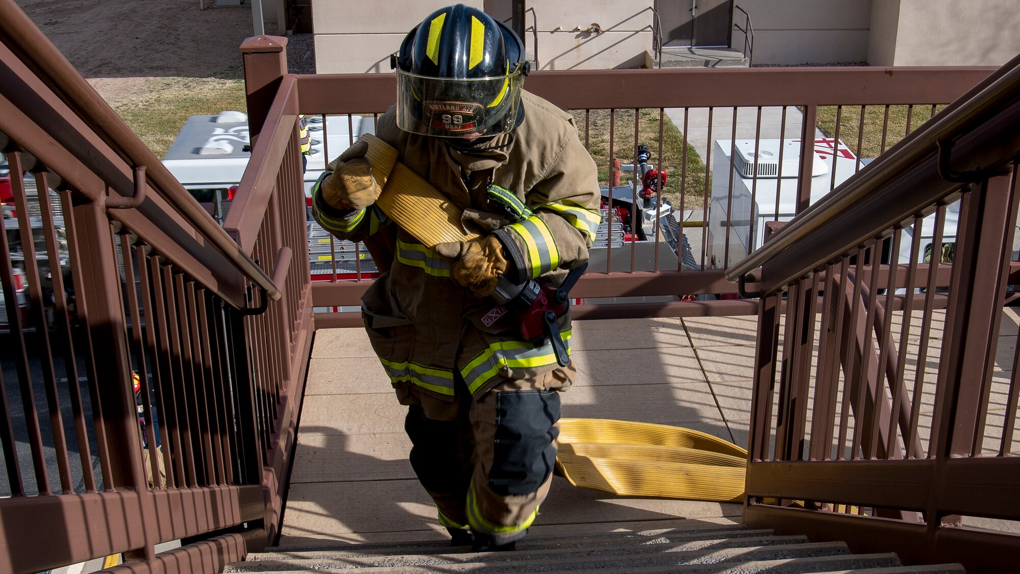 Firefighter walks up stairs.