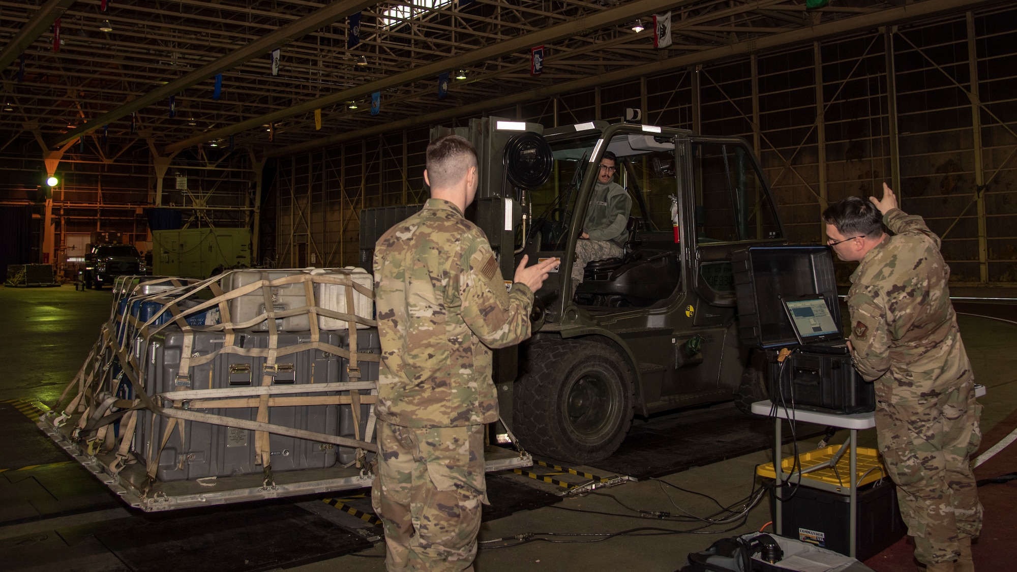 U.S. Air Force Staff Sgt. Daniel Cruz, a 35th Logistics Readiness Squadron outbound cargo supervisor, drives a forklift over the Weigh-In-Motion scales at Misawa Air Base, Japan, March 13, 2020. The WIM scale saves countless man-hours by collecting necessary data all at once through an advanced system of sensors, dynamic measurement system and data archiving. (U.S. Air Force photo by Airman 1st Class China M. Shock)