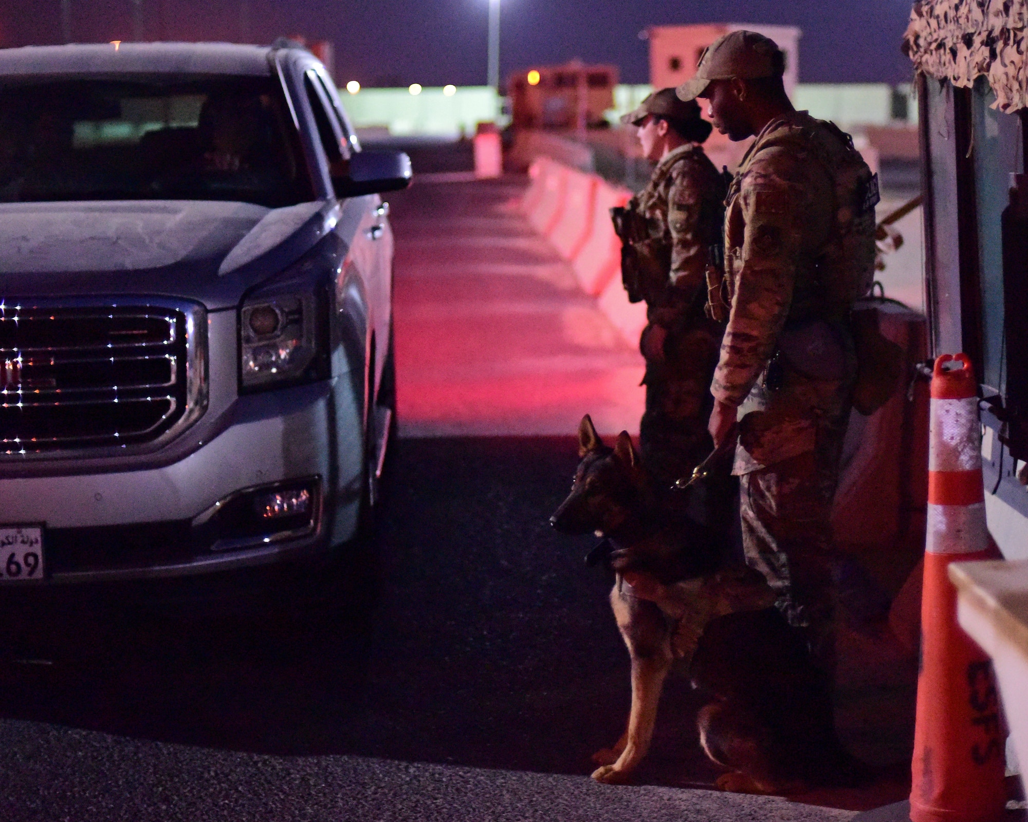 Military Working Dog handler prepares to execute a vehicle search