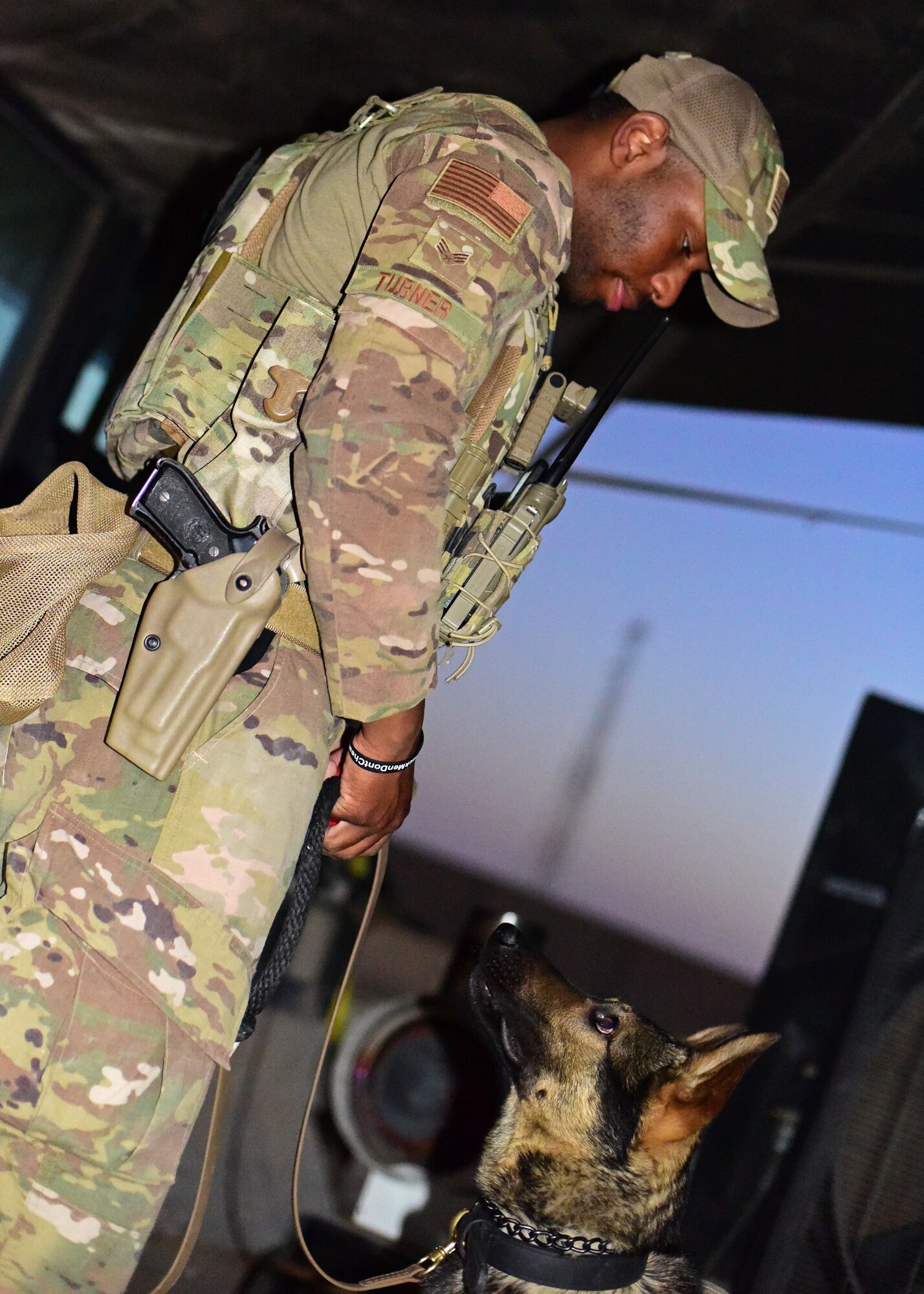 Military Working Dog handler interacts with canine