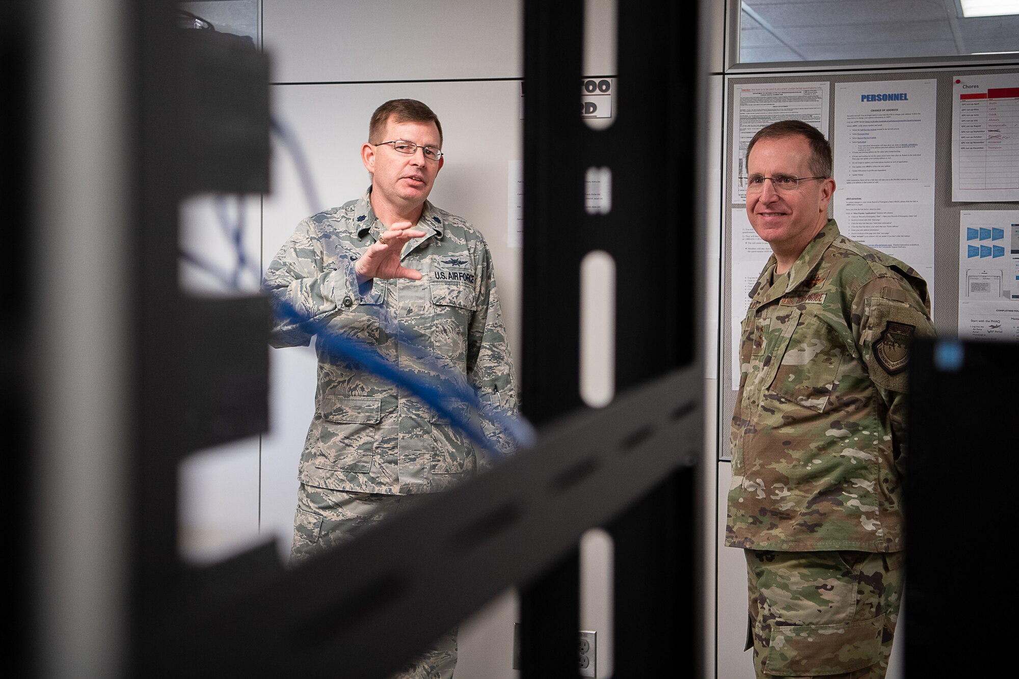 Col. Scott Townsend (left), 205th Engineering and Installation Squadron (205th EIS) commander, speaks to U.S. Air Force Lt. Gen. Jim Slife (right), commander of Air Force Special Operations Command, Hurlburt Field, Fla., about an innovation of 205th Airmen during an immersion tour of the 137th Special Operations Wing at Will Rogers Air National Guard Base in Oklahoma City, March 7, 2020. Several 205th EIS Airmen developed and designed the Cyber Training Retention Operations Network, which is a comprehensive and cost-effective program that provides hands-on training in place of simulations. (U.S. Air National Guard photo by Tech. Sgt. Kasey M. Phipps)