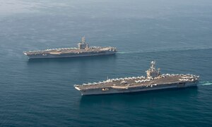 The aircraft carriers USS Dwight D. Eisenhower (CVN 69), top, and USS Harry S. Truman (CVN 75) transit the Arabian Sea March 18, 2020. The Harry S. Truman Carrier Strike Group is deployed to the U.S. 5th Fleet area of operations in support of naval operations to ensure maritime stability and security in the Central Region, connecting the Mediterranean and the Pacific through the western Indian Ocean and three strategic choke points.