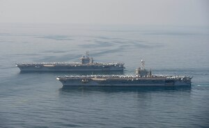 The aircraft carriers USS Dwight D. Eisenhower (CVN 69), top, and USS Harry S. Truman (CVN 75) transit the Arabian Sea March 18, 2020. The Harry S. Truman Carrier Strike Group is deployed to the U.S. 5th Fleet area of operations in support of naval operations to ensure maritime stability and security in the Central Region, connecting the Mediterranean and the Pacific through the western Indian Ocean and three strategic choke points.