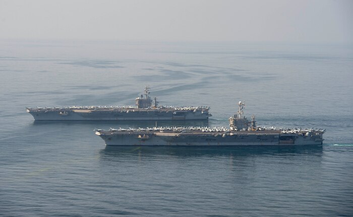 The aircraft carriers USS Dwight D. Eisenhower (CVN 69), top, and USS Harry S. Truman (CVN 75) transit the Arabian Sea March 18, 2020. The Harry S. Truman Carrier Strike Group is deployed to the U.S. 5th Fleet area of operations in support of naval operations to ensure maritime stability and security in the Central Region, connecting the Mediterranean and the Pacific through the western Indian Ocean and three strategic choke points.
