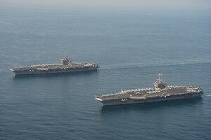 The aircraft carriers USS Dwight D. Eisenhower (CVN 69), left, and USS Harry S. Truman (CVN 75) transit the Arabian Sea March 18, 2020. The Harry S. Truman Carrier Strike Group is deployed to the U.S. 5th Fleet area of operations in support of naval operations to ensure maritime stability and security in the Central Region, connecting the Mediterranean and the Pacific through the Western Indian Ocean and three strategic choke points.