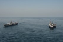 The aircraft carriers USS Dwight D. Eisenhower (CVN 69), left, and USS Harry S. Truman (CVN 75) transit the Arabian Sea March 18, 2020. The Harry S. Truman Carrier Strike Group is deployed to the U.S. 5th Fleet area of operations in support of naval operations to ensure maritime stability and security in the Central Region, connecting the Mediterranean and the Pacific through the Western Indian Ocean and three strategic choke points.