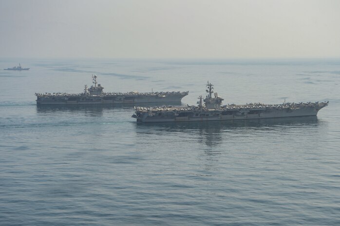 The aircraft carriers USS Dwight D. Eisenhower (CVN 69), front, and USS Harry S. Truman (CVN 75), center, and the guided-missile destroyer USS Lassen (DDG 82) transit the Arabian Sea March 18, 2020. The Harry S. Truman Carrier Strike Group is deployed to the U.S. 5th Fleet area of operations in support of naval operations to ensure maritime stability and security in the Central Region, connecting the Mediterranean and the Pacific through the Western Indian Ocean and three strategic choke points.