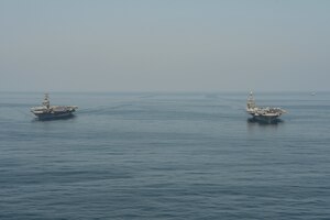 The aircraft carriers USS Dwight D. Eisenhower (CVN 69), left, and USS Harry S. Truman (CVN 75) transit the Arabian Sea March 18, 2020. The Harry S. Truman Carrier Strike Group is deployed to the U.S. 5th Fleet area of operations in support of naval operations to ensure maritime stability and security in the Central Region, connecting the Mediterranean and the Pacific through the Western Indian Ocean and three strategic choke points.