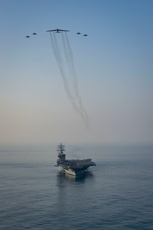 The aircraft carrier USS Dwight D. Eisenhower (CVN 69) conducts a combined air wing operation with a B-52 Bomber from U.S. Air Forces Central Command in the Arabian Sea, March 18, 2020. Ike is deployed to the U.S. 5th Fleet area of operations in support of naval operations to ensure maritime stability and security in the Central Region, connecting the Mediterranean and Pacific through the Western Indian Ocean and three strategic choke points.