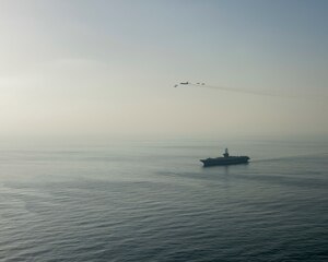 The aircraft carrier USS Dwight D. Eisenhower (CVN 69) conducts a combined air wing operation with a B-52 Bomber from U.S. Air Forces Central Command in the Arabian Sea, March 18, 2020. Ike is deployed to the U.S. 5th Fleet area of operations in support of naval operations to ensure maritime stability and security in the Central Region, connecting the Mediterranean and Pacific through the Western Indian Ocean and three strategic choke points.