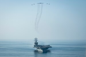 The aircraft carrier USS Dwight D. Eisenhower (CVN 69) conducts a combined air wing operation with a B-52 Bomber from U.S. Air Forces Central Command in the Arabian Sea, March 18, 2020. Ike is deployed to the U.S. 5th Fleet area of operations in support of naval operations to ensure maritime stability and security in the Central Region, connecting the Mediterranean and Pacific through the Western Indian Ocean and three strategic choke points.