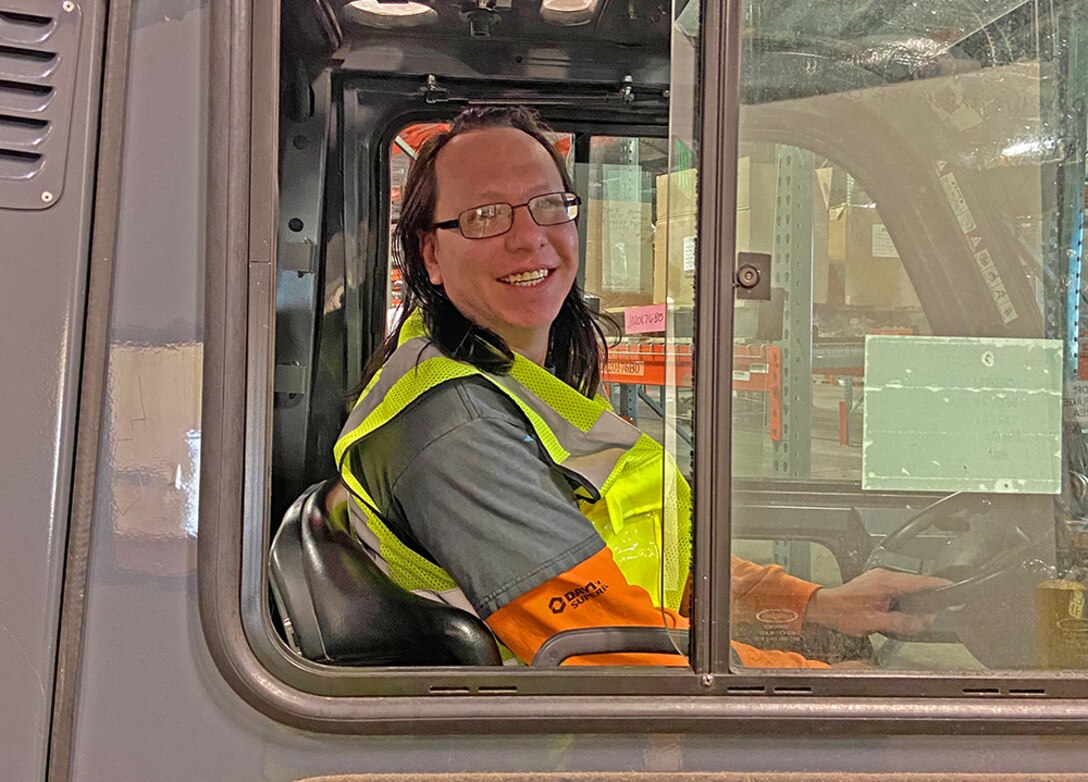 Forklift driver poses for a photo