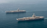 The aircraft carriers USS Dwight D. Eisenhower (CVN 69), top, and USS Harry S. Truman (CVN 75) transit the Arabian Sea March 18, 2020. The Harry S. Truman Carrier Strike Group is deployed to the U.S. 5th Fleet area of operations in support of naval operations to ensure maritime stability and security in the Central Region, connecting the Mediterranean and the Pacific through the western Indian Ocean and three strategic choke points.